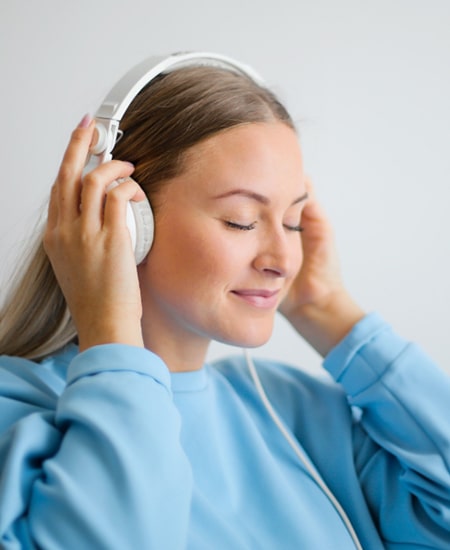 Relaxed woman listening to music with her headphones