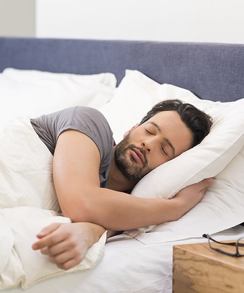 A man sleeping soundly after his sleep apnea treatment