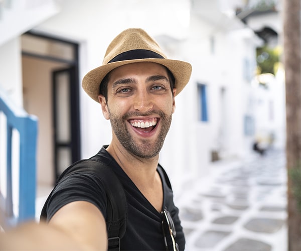 A man taking a selfie while showing off his new smile